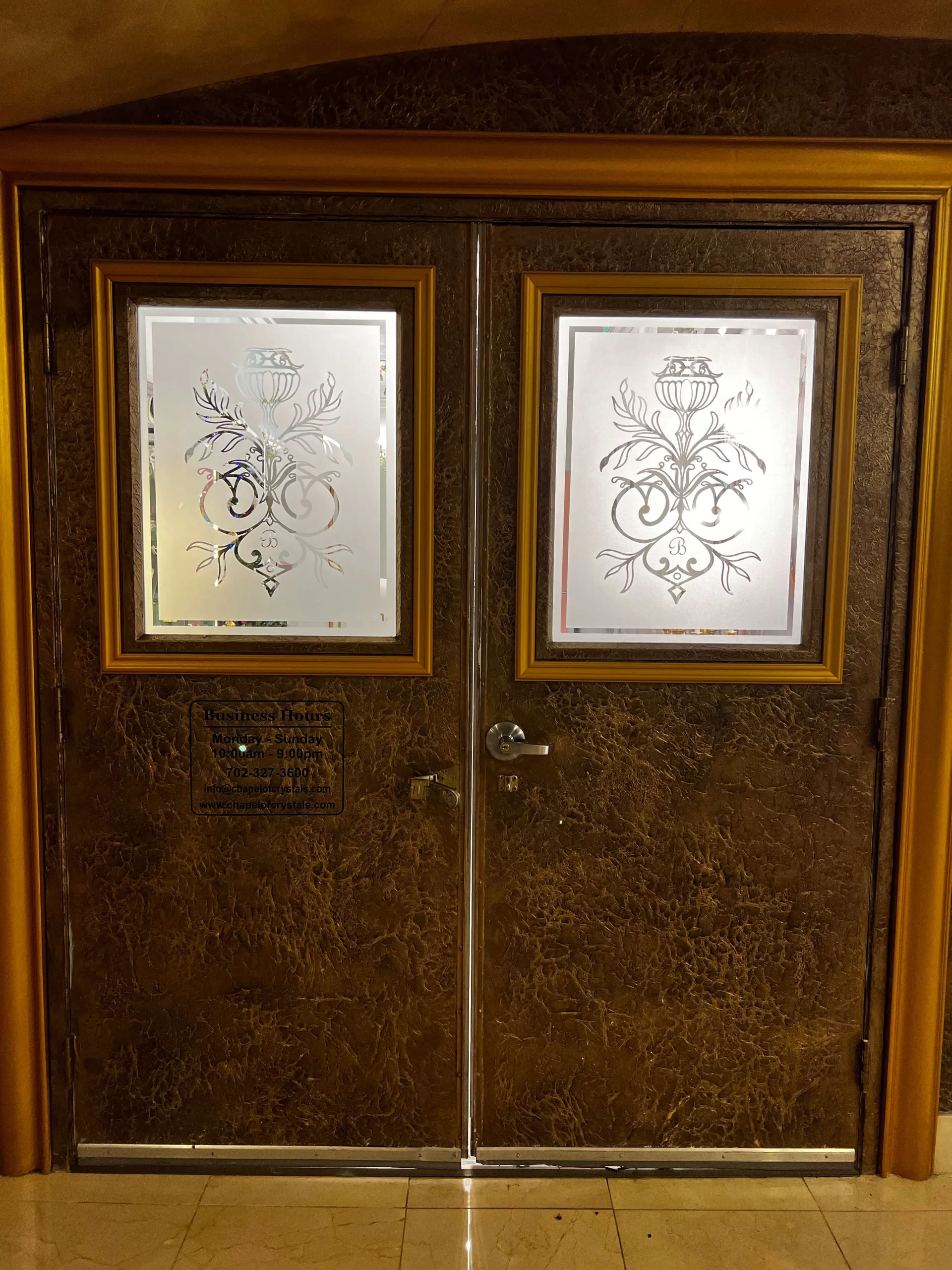 Custom etched glass wedding venue doors after replacing old stickers with elegant design